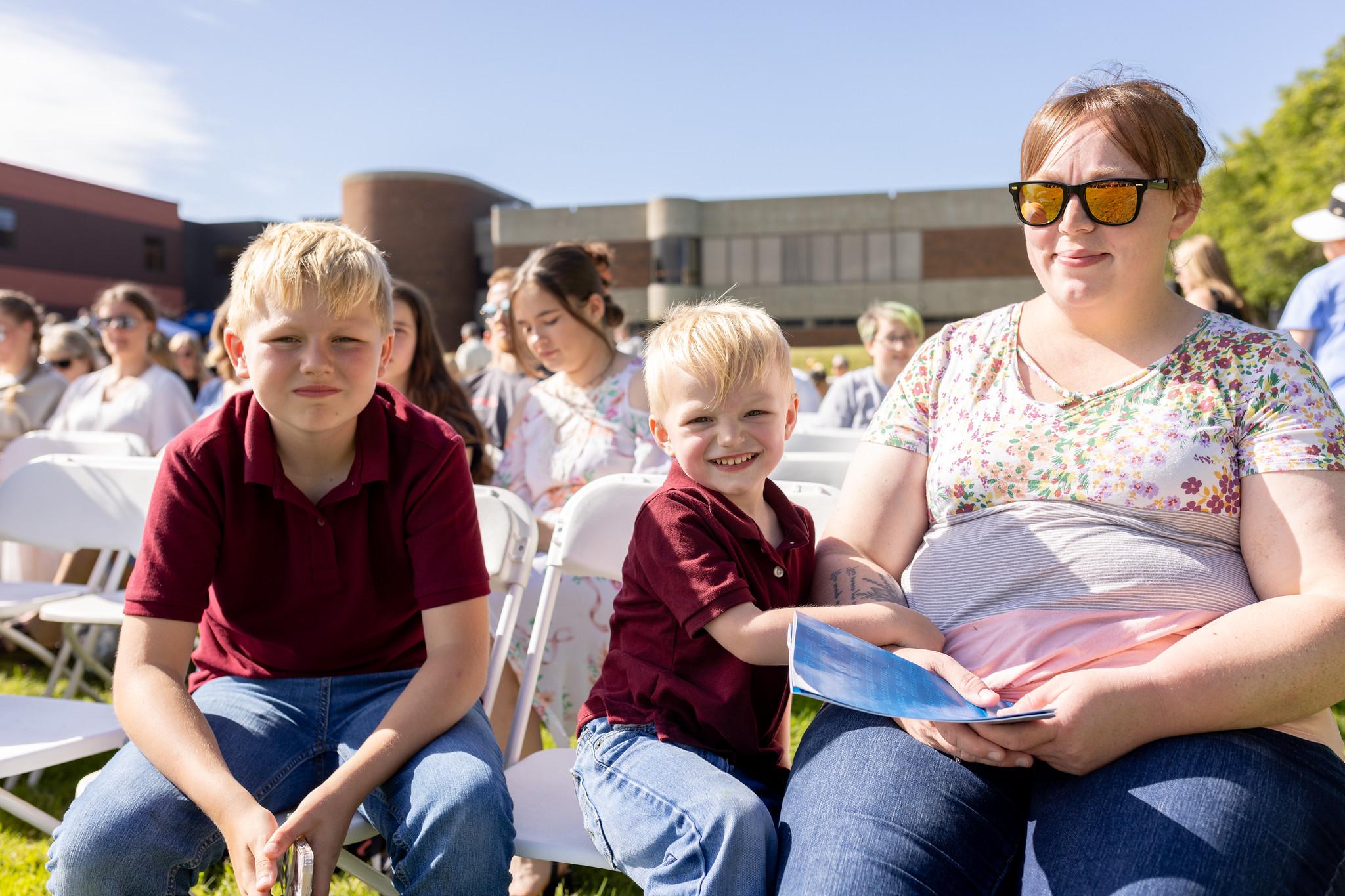 Photo of a family sitting at Commencement